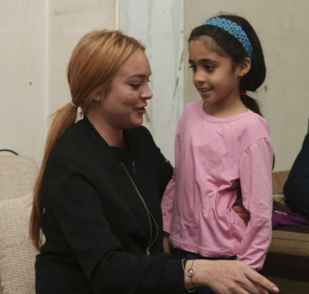 ISTANBUL,  TURKEY - SEPTEMBER 26: Hollywood actress Lindsay Lohan (L) speaks with a Syrian refugee girl at her house after the visit to a hospital built for Syrian refugees at Sultanbeyli suburb of Istanbul,  Turkey on September 26,  2016. (Photo by Stringer/Anadolu Agency/Getty Images)