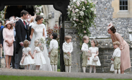 Kate,  Duchess of Cambridge,  right,  stands with her son Prince George as she looks across at Pippa Middleton and James Matthews after their wedding at St Mark's Church in Englefield,  England Saturday,  May 20,  2017. Middleton,  the sister of Kate,  Duchess of Cambridge married hedge fund manager James Matthews in a ceremony Saturday where her niece and nephew Prince George and Princess Charlotte was in the wedding party,  along with sister Kate and princes Harry and William. (AP Photo/Kirsty Wigglesworth,  Pool)